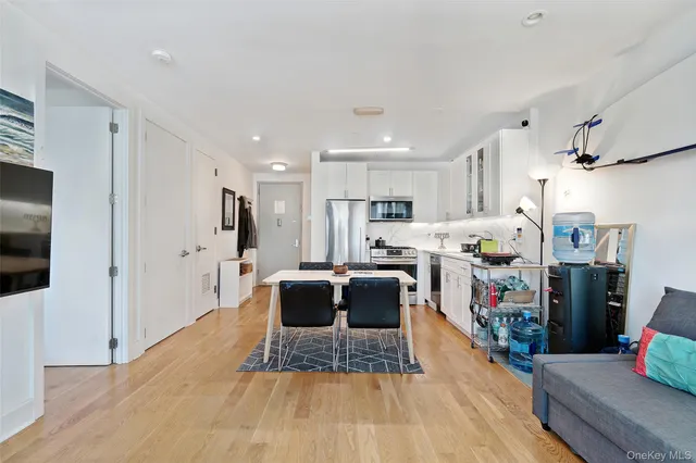 a view of kitchen with stainless steel appliances refrigerator stove microwave and cabinets
