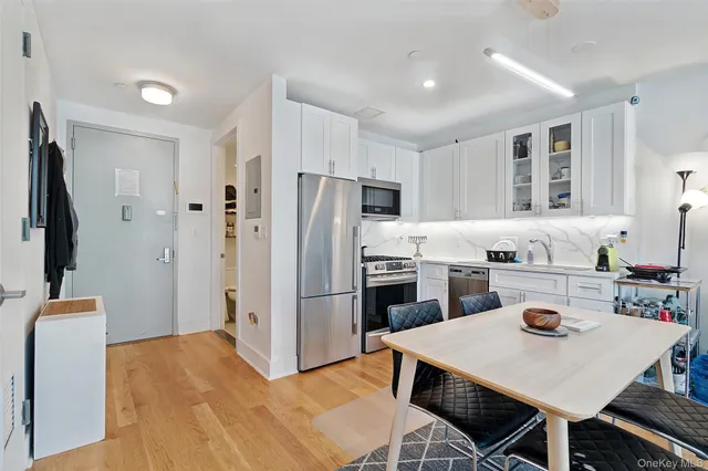 a kitchen with refrigerator cabinets dining table and chairs