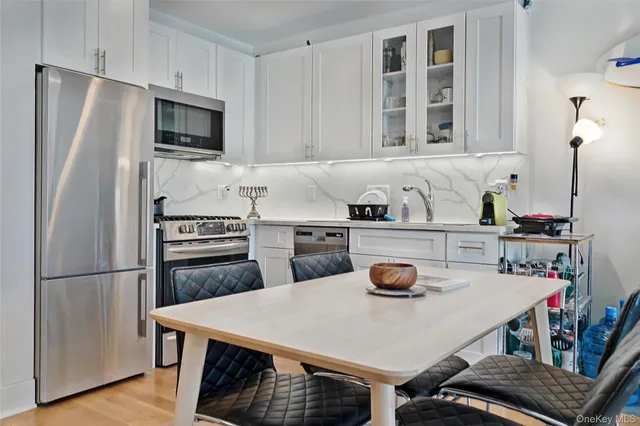 a kitchen with a table chairs and refrigerator