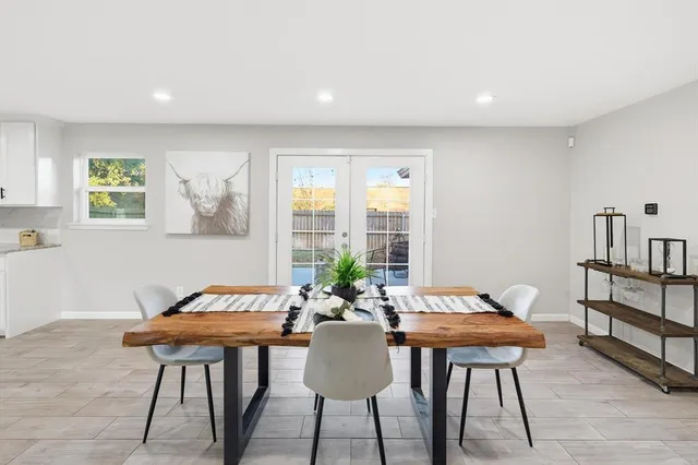 a view of a dining room with furniture and a potted plant
