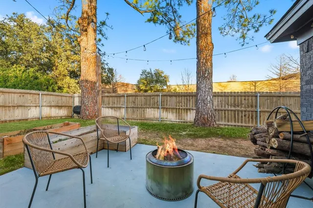 a view of a patio with a table chairs and a potted plant