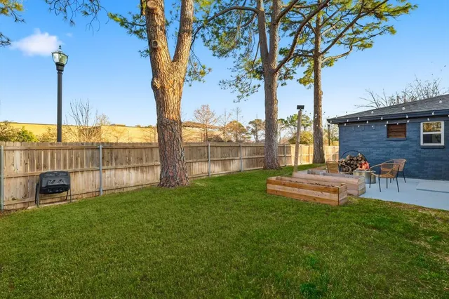 a view of a backyard with a table and chairs