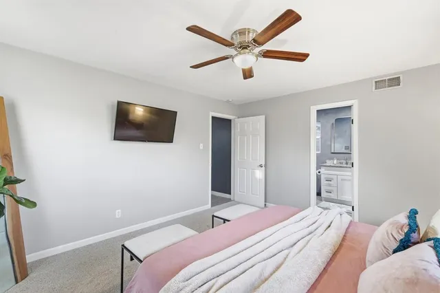 a bedroom with a large bed and a flat screen tv