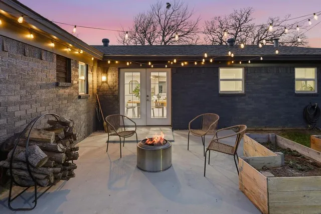 a view of a patio with iron fence