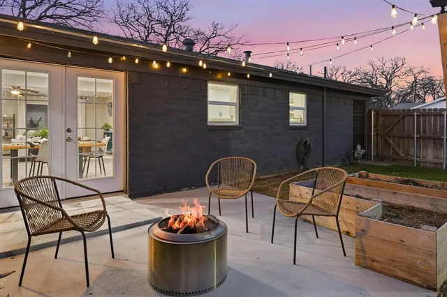 a backyard of a house with barbeque oven table and chairs