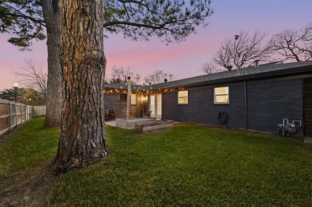 a view of a backyard with large trees