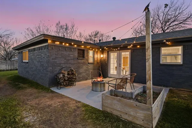a view of a patio with couches table and chairs and potted plants