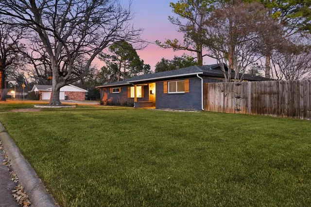 a front view of house with yard and trees