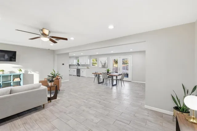 a living room with furniture and white walls