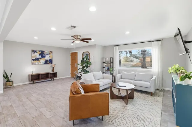 a living room with furniture and flowers
