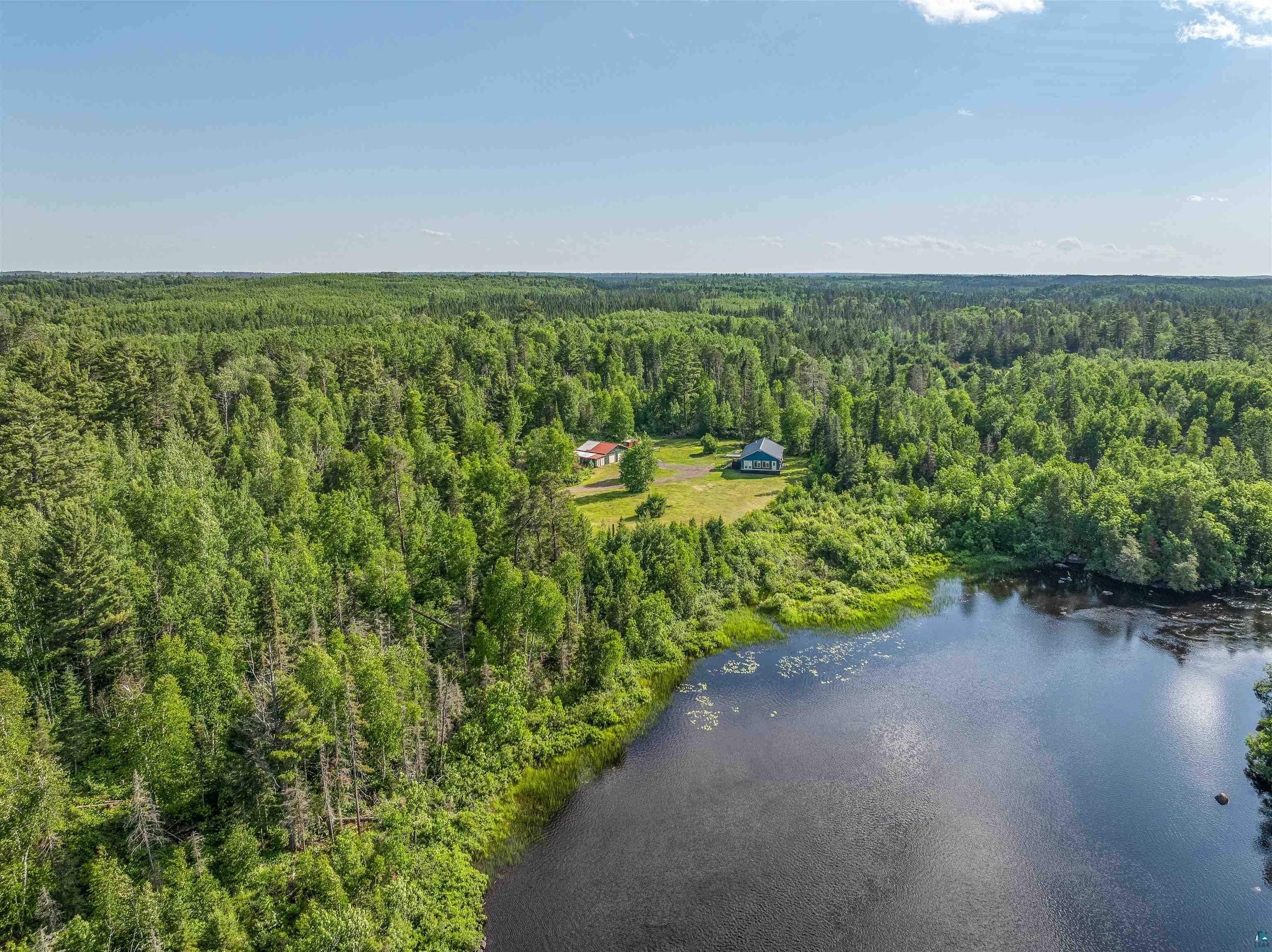 1383 Kelly Trail Isabella, MN 55607 - Photo 20 of 40 Aerial view of a heavily wooded area and a nearby body of water