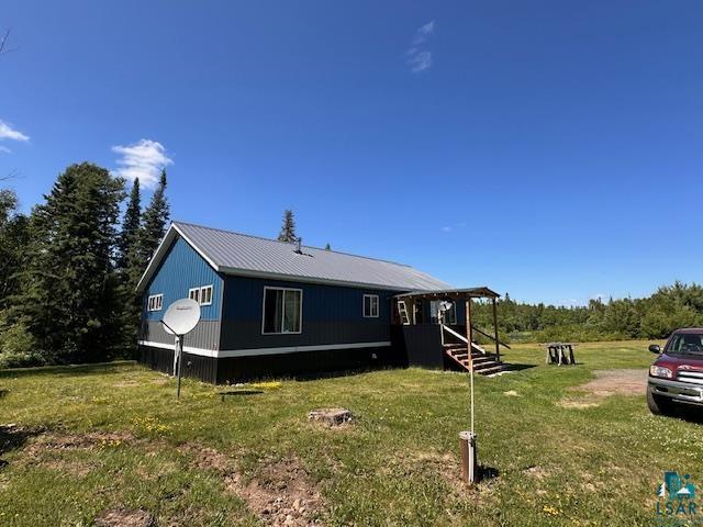1383 Kelly Trail Isabella, MN 55607 - Photo 28 of 40 Back of house featuring a lawn and a metal roof
