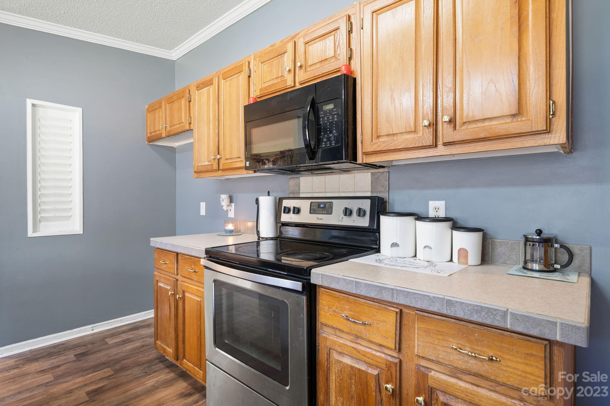160 Bost Nursery Road Maiden, NC 28650 - Photo 12 of 27 a kitchen with stainless steel appliances granite countertop a sink a stove and microwave
