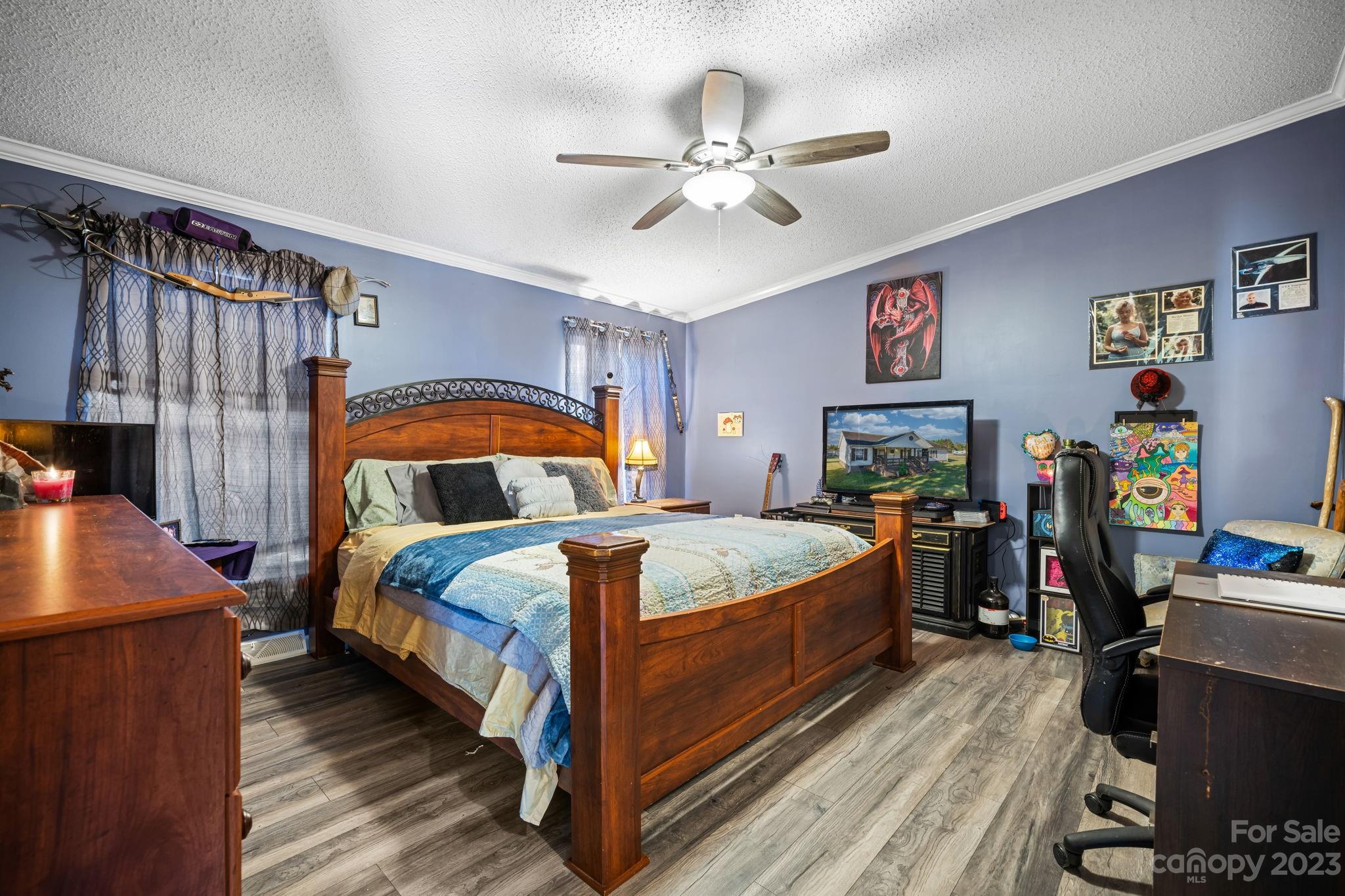 160 Bost Nursery Road Maiden, NC 28650 - Photo 18 of 27 a bedroom with a bed and a chandelier