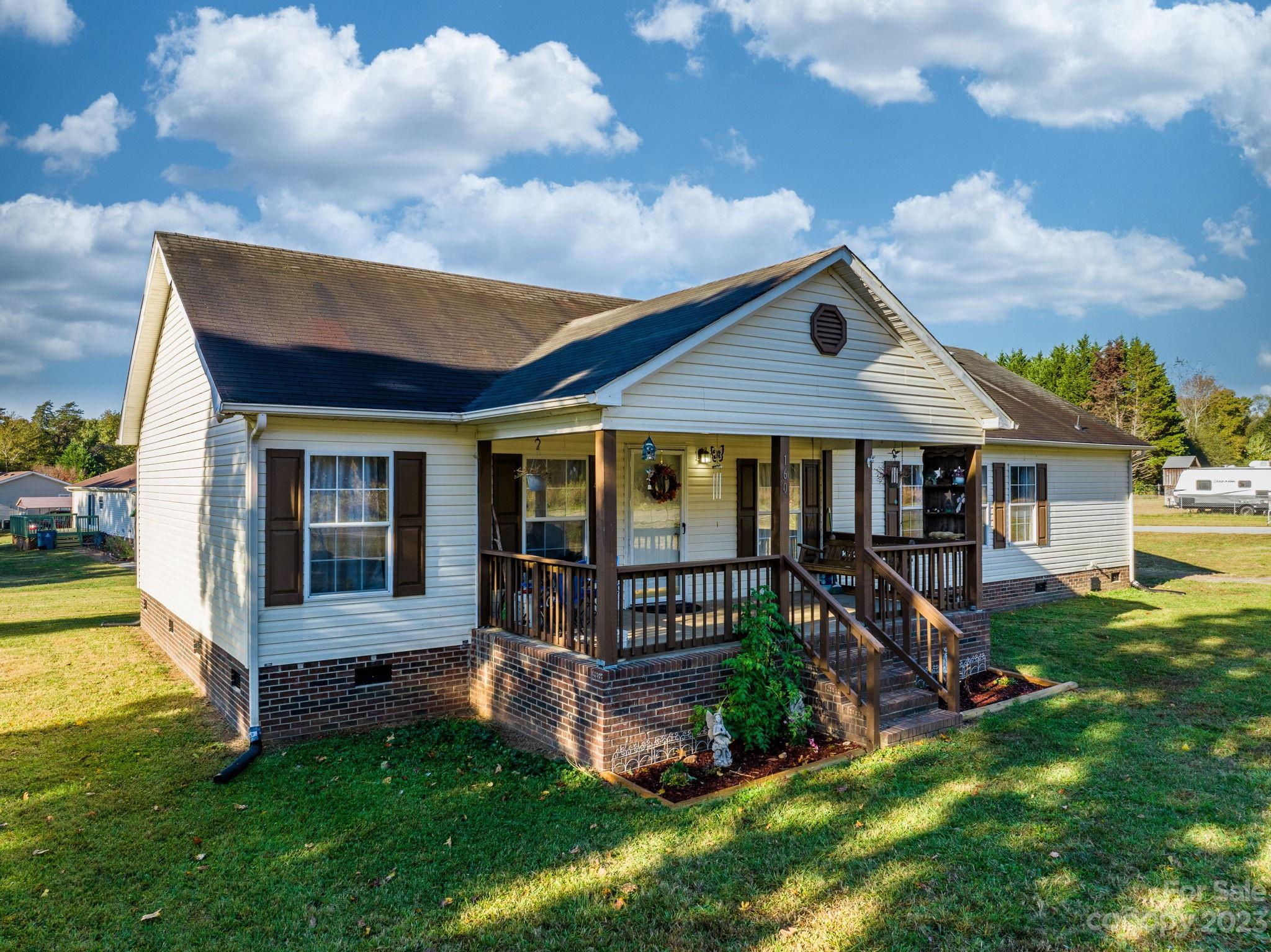 160 Bost Nursery Road Maiden, NC 28650 - Photo 2 of 27 a front view of a house with a yard table and chairs