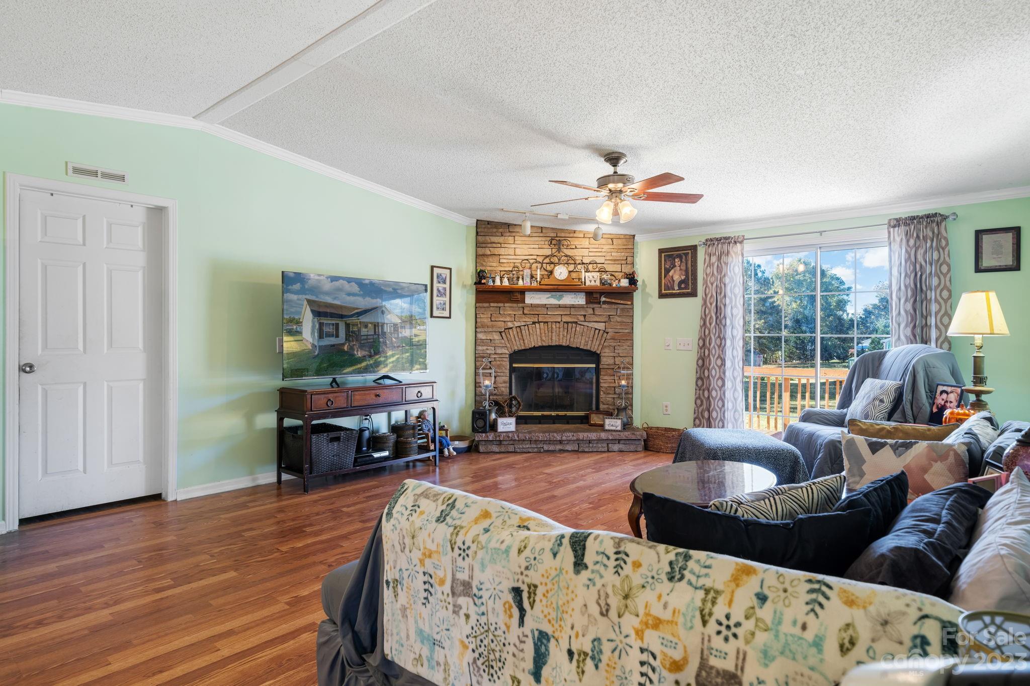 160 Bost Nursery Road Maiden, NC 28650 - Photo 7 of 27 a living room with furniture a fireplace and a flat screen tv