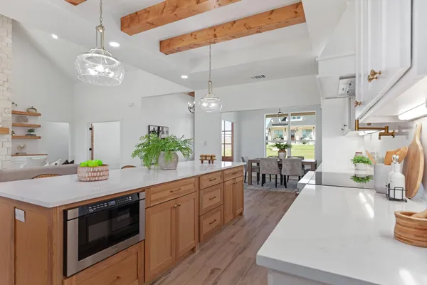 a kitchen with stainless steel appliances kitchen island a large island in the center