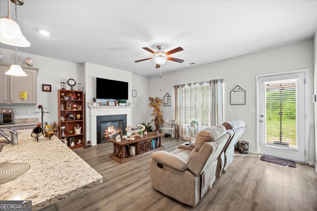 7503 Knoll Hollow Road Lithonia, GA 30058 - Photo 11 of 34 a living room with fireplace furniture and a large window