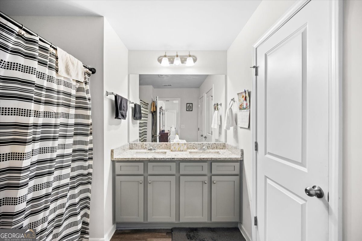 7503 Knoll Hollow Road Lithonia, GA 30058 - Photo 17 of 34 a bathroom with a sink and a mirror