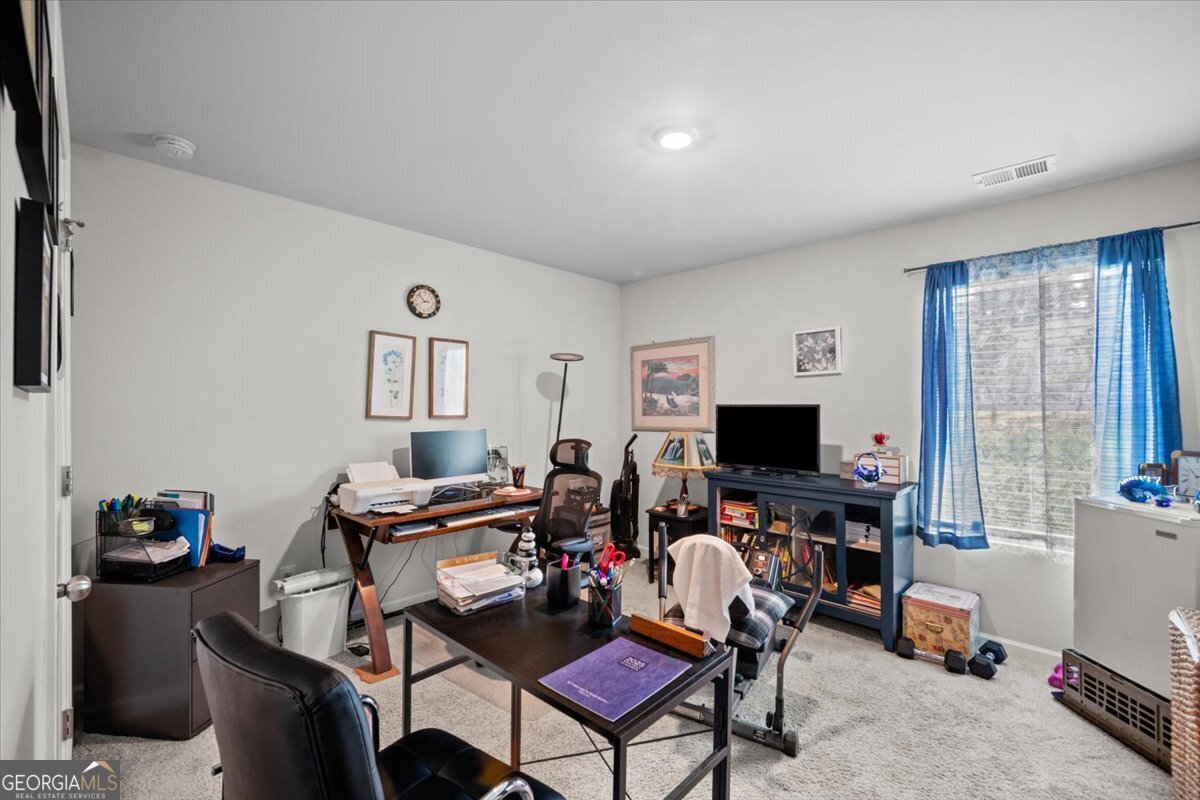7503 Knoll Hollow Road Lithonia, GA 30058 - Photo 20 of 34 a view of a livingroom with furniture and a flat screen tv