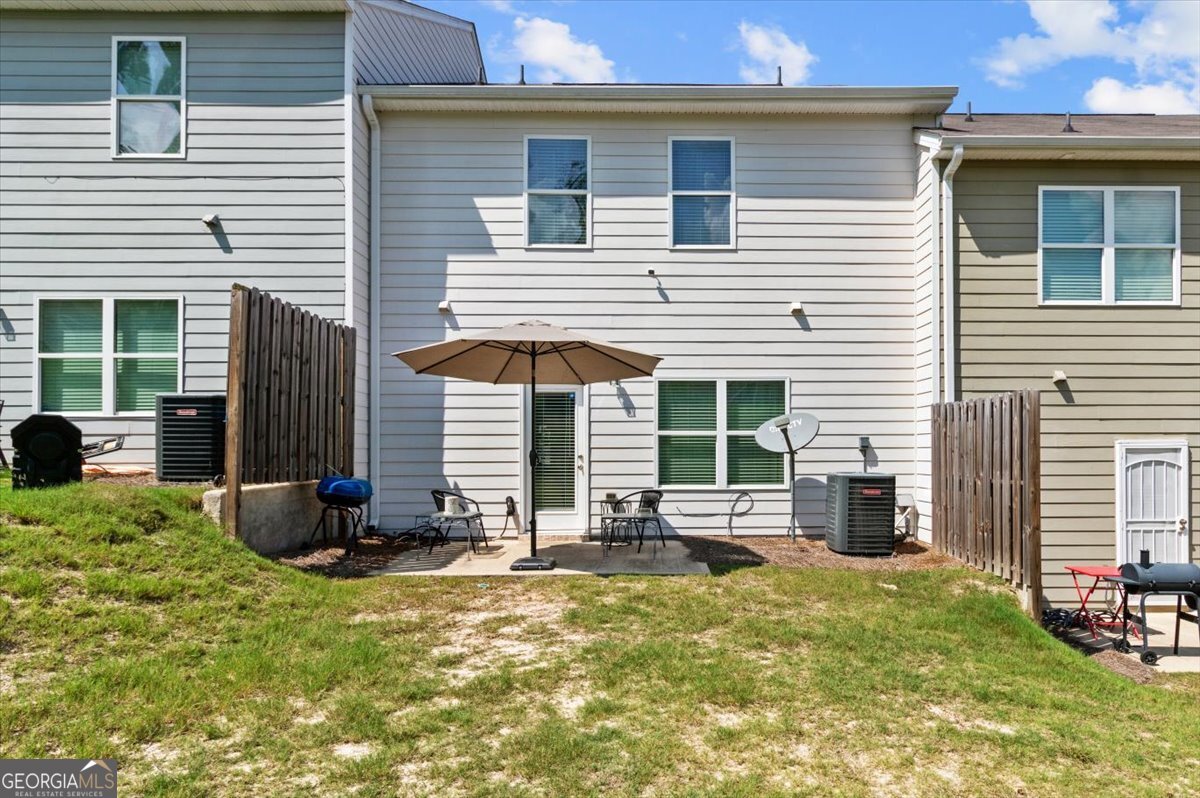 7503 Knoll Hollow Road Lithonia, GA 30058 - Photo 24 of 34 a front view of a house with a patio