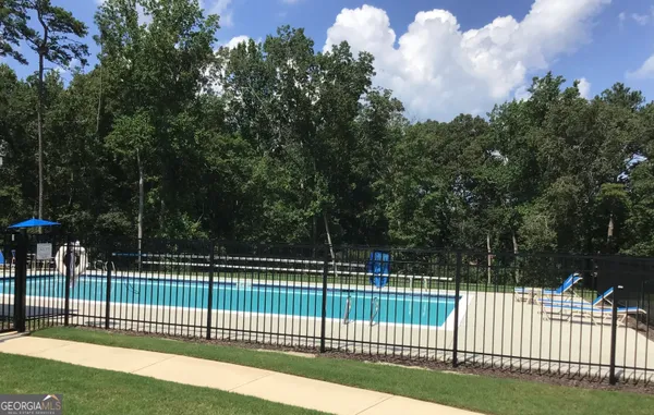 a view of a fence and trees