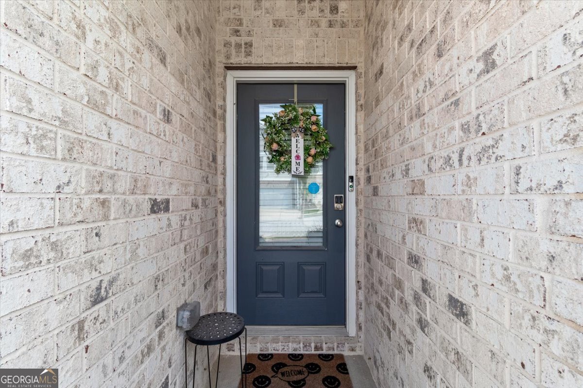 7503 Knoll Hollow Road Lithonia, GA 30058 - Photo 4 of 34 a bathroom with a window and a shower