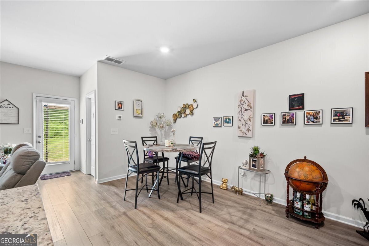 7503 Knoll Hollow Road Lithonia, GA 30058 - Photo 10 of 34 a view of a livingroom with furniture and wooden floor