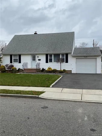 a view of a livingroom with wooden floor and stairs