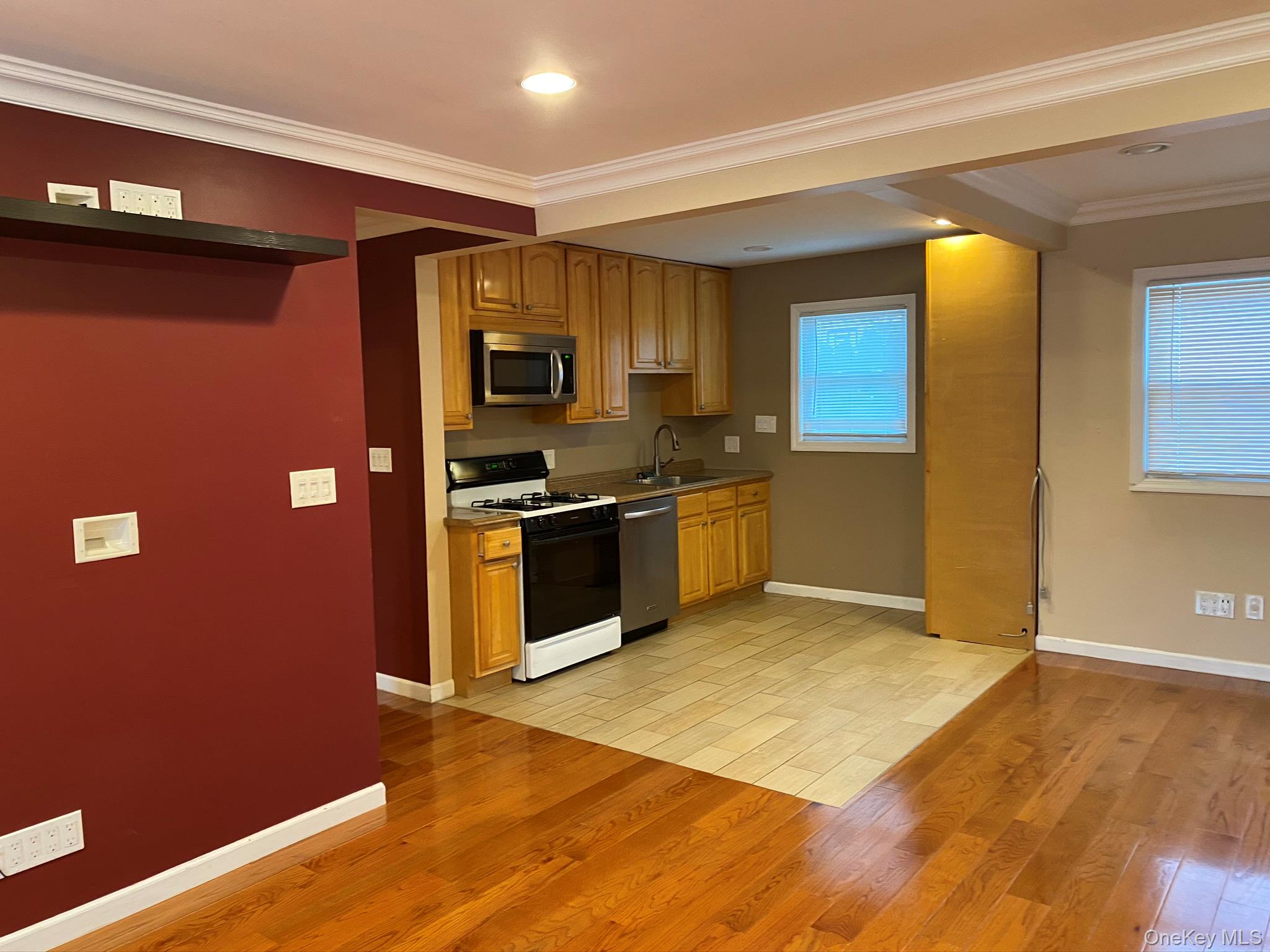 25 Woodhollow Road Albertson, NY 11507 - Photo 3 of 15 a kitchen with stainless steel appliances granite countertop a refrigerator a sink and a stove