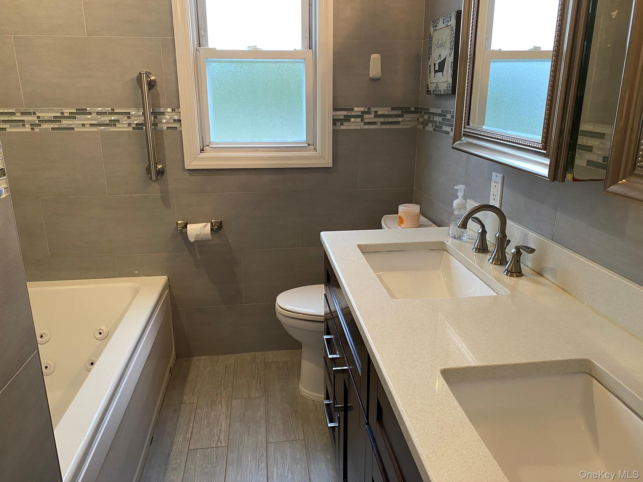 25 Woodhollow Road Albertson, NY 11507 - Photo 5 of 15 a bathroom with a sink and a mirror