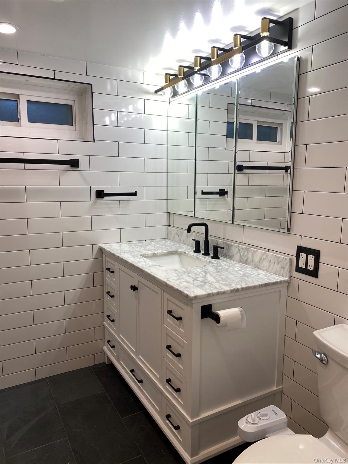 25 Woodhollow Road Albertson, NY 11507 - Photo 10 of 15 a bathroom with a sink and a mirror