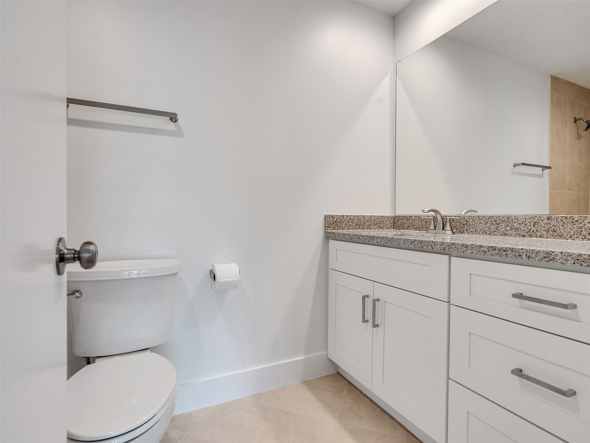 2829 Timmons Lane, Unit 204 Houston, TX 77027 - Photo 18 of 32 a bathroom with a granite countertop toilet and a sink