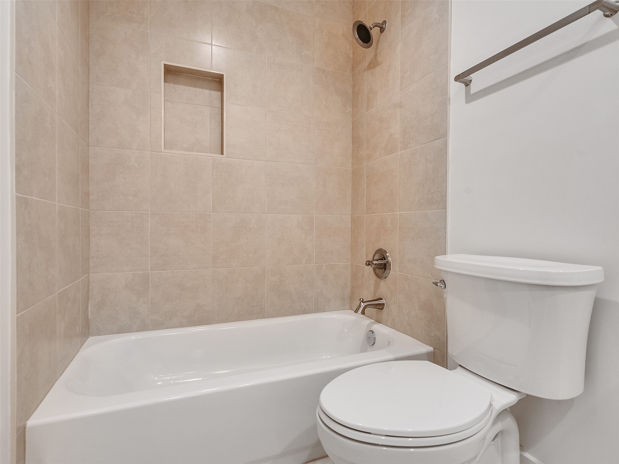 2829 Timmons Lane, Unit 204 Houston, TX 77027 - Photo 19 of 32 a white toilet and tub sitting next to a bathroom sink