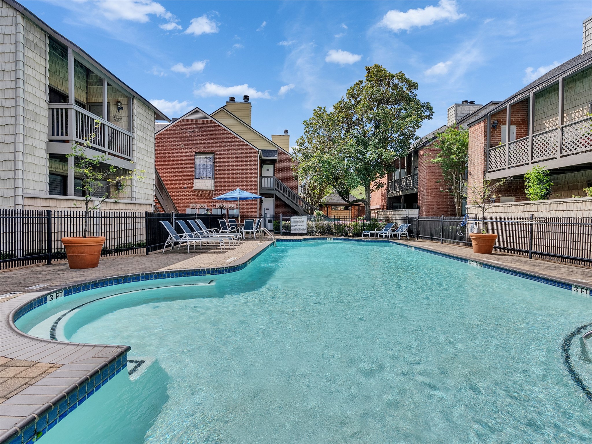 2829 Timmons Lane, Unit 204 Houston, TX 77027 - Photo 25 of 32 a house view with a sitting space fire pit and outdoor space