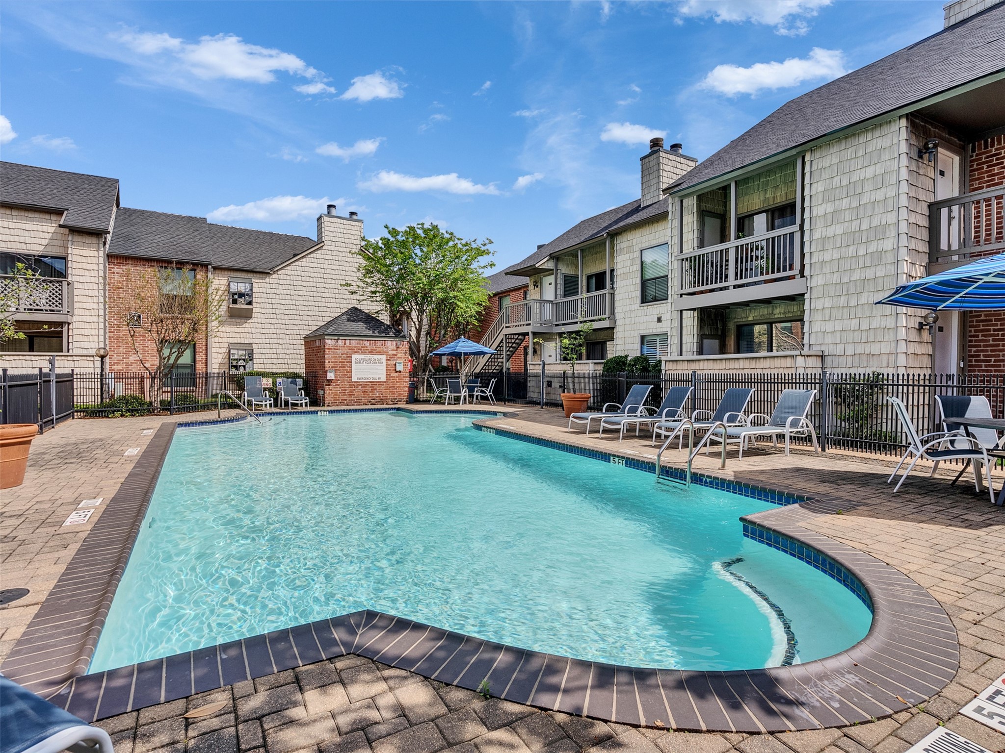 2829 Timmons Lane, Unit 204 Houston, TX 77027 - Photo 26 of 32 a swimming pool with outdoor seating and yard