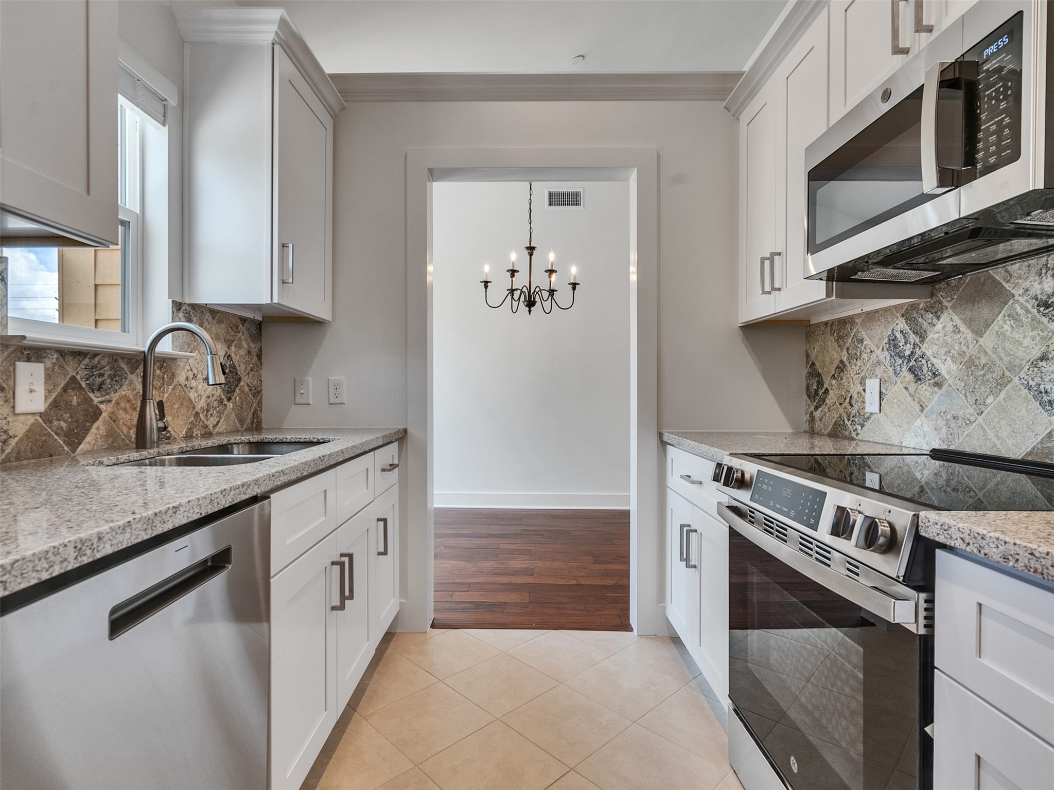 2829 Timmons Lane, Unit 204 Houston, TX 77027 - Photo 6 of 32 a kitchen with stainless steel appliances granite countertop a sink and a stove