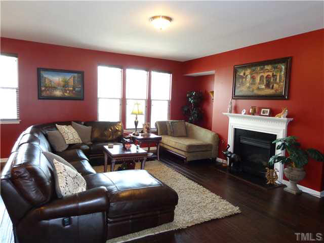 1537 Rodessa Run Raleigh, NC 27607 - Photo 6 of 25 Spacious living room with lots of light and gas logs.