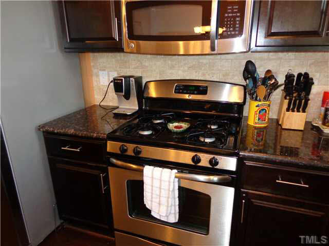 1537 Rodessa Run Raleigh, NC 27607 - Photo 10 of 25 Gas stove, tile backsplash & built in microwave.