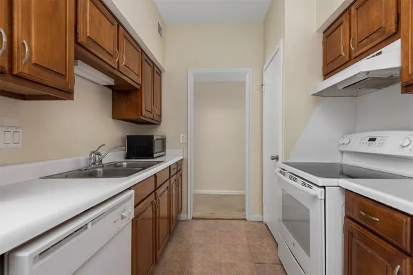 a kitchen with a sink and a stove top oven