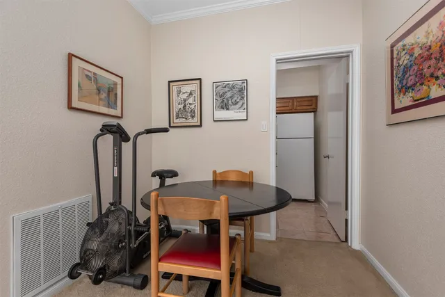 a view of a workspace room with furniture and wooden floor