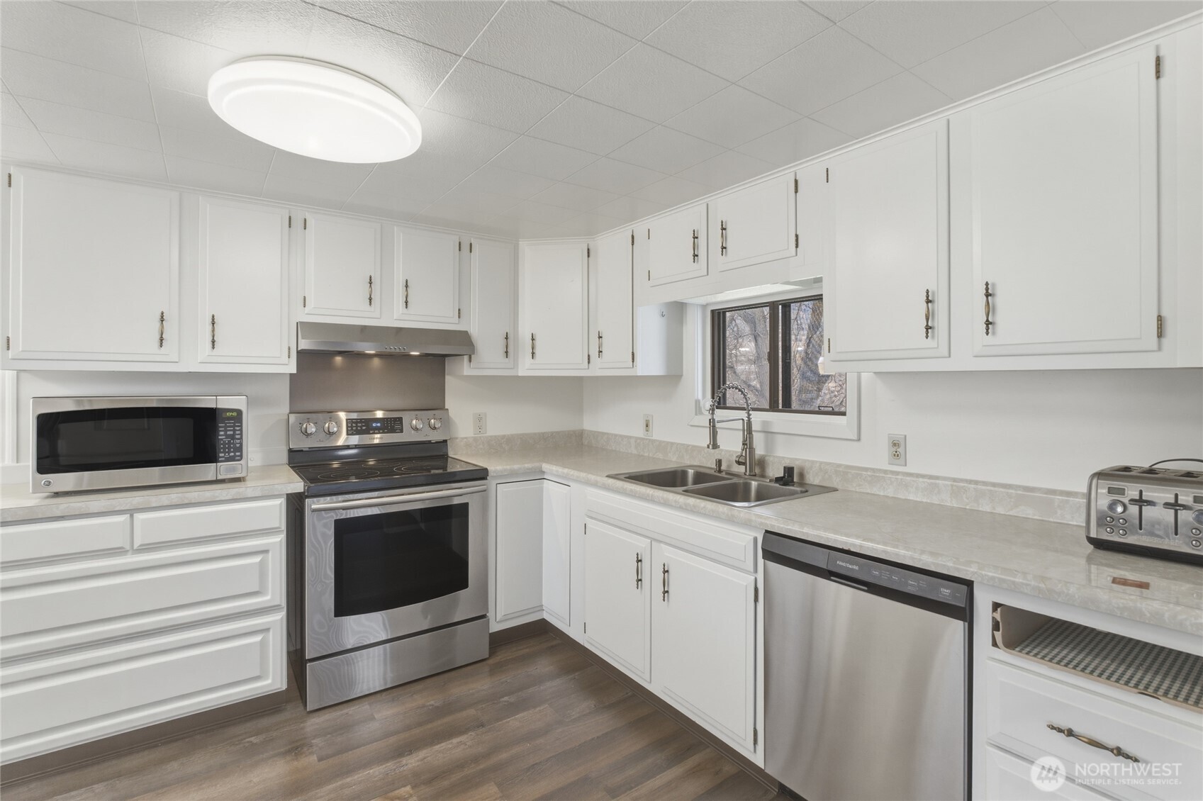 5 Alaska Street Malott, WA 98829 - Photo 11 of 38 a kitchen with stainless steel appliances granite countertop a sink stove a microwave and cabinets