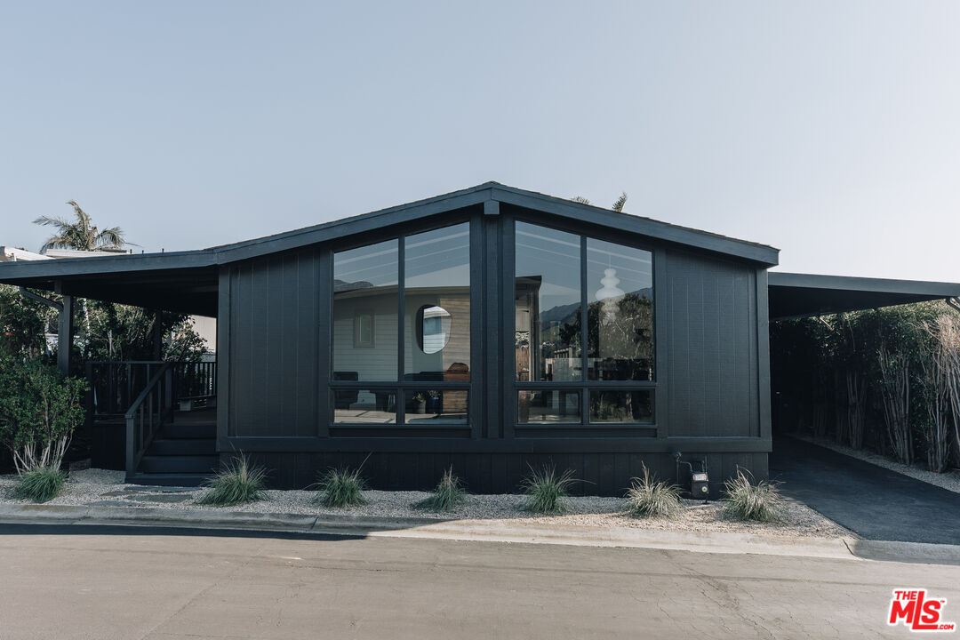 29500 Heathercliff Road, Unit 220 Malibu, CA 90265 - Photo 1 of 43 a view of a house with a yard