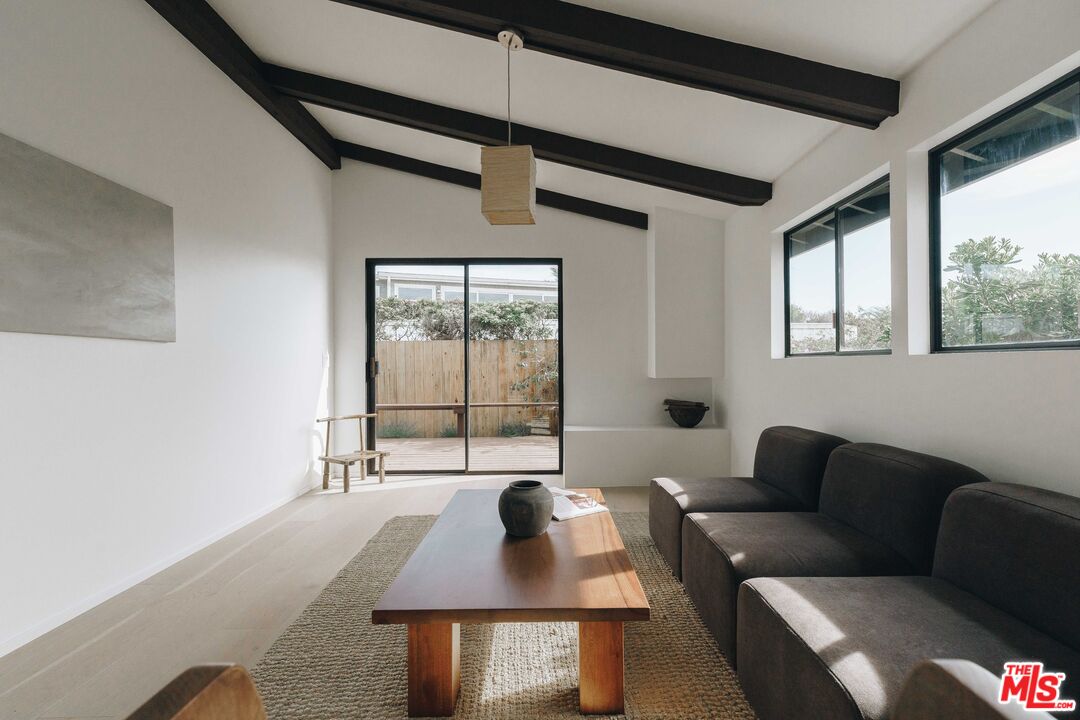 29500 Heathercliff Road, Unit 220 Malibu, CA 90265 - Photo 15 of 43 a living room with furniture and a large window