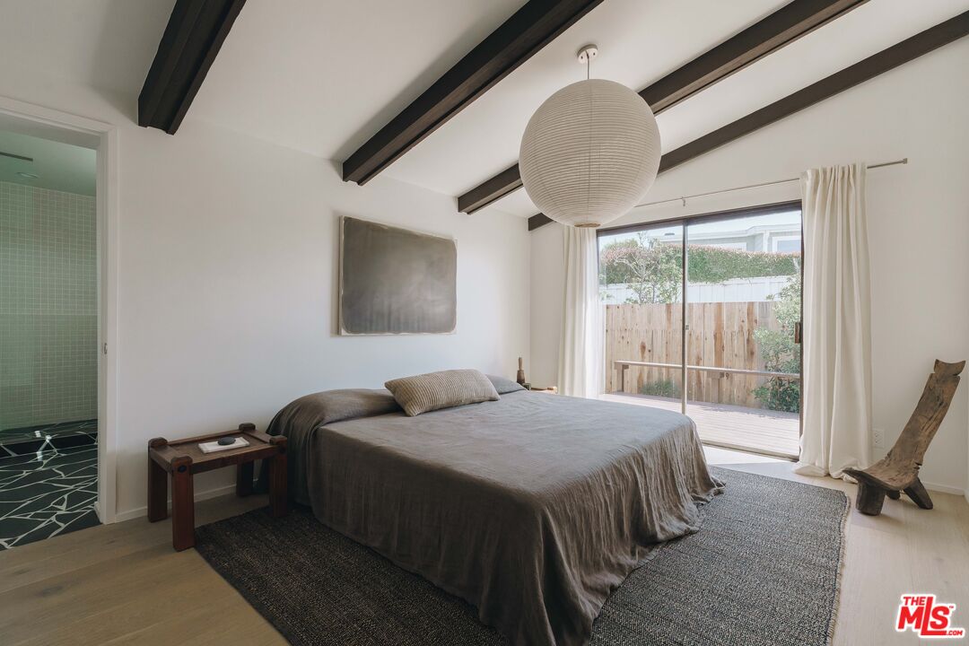 29500 Heathercliff Road, Unit 220 Malibu, CA 90265 - Photo 18 of 43 a bedroom with a bed a window and dresser