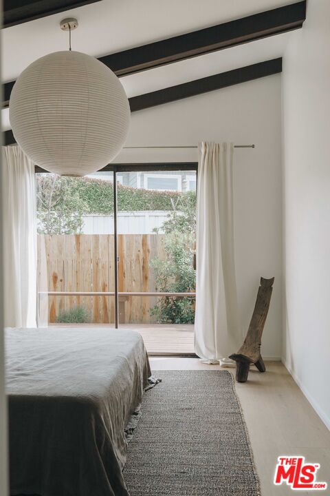 29500 Heathercliff Road, Unit 220 Malibu, CA 90265 - Photo 19 of 43 a bedroom with a bed and a large window