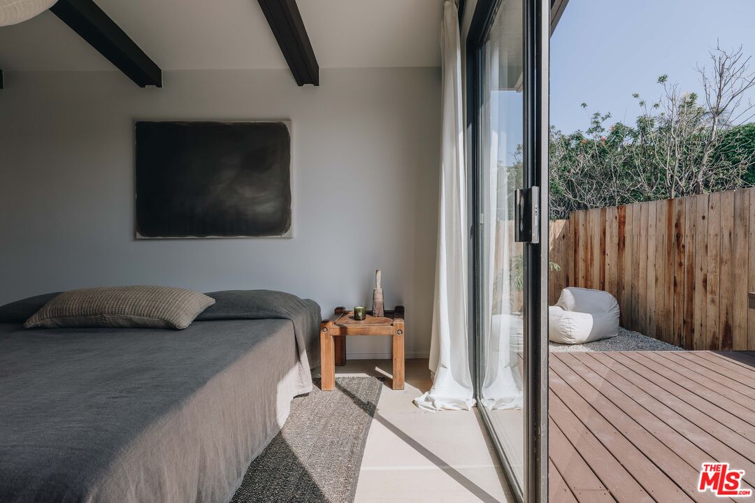 29500 Heathercliff Road, Unit 220 Malibu, CA 90265 - Photo 20 of 43 a bedroom with a bed and a chair