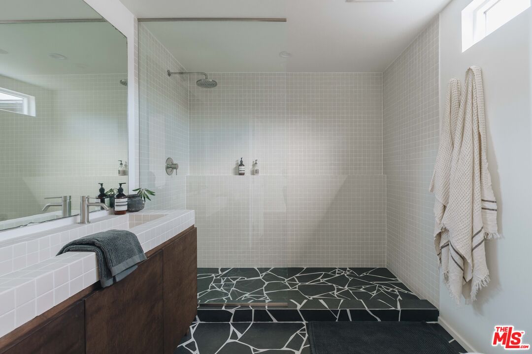 29500 Heathercliff Road, Unit 220 Malibu, CA 90265 - Photo 21 of 43 a bathroom with a sink and a mirror