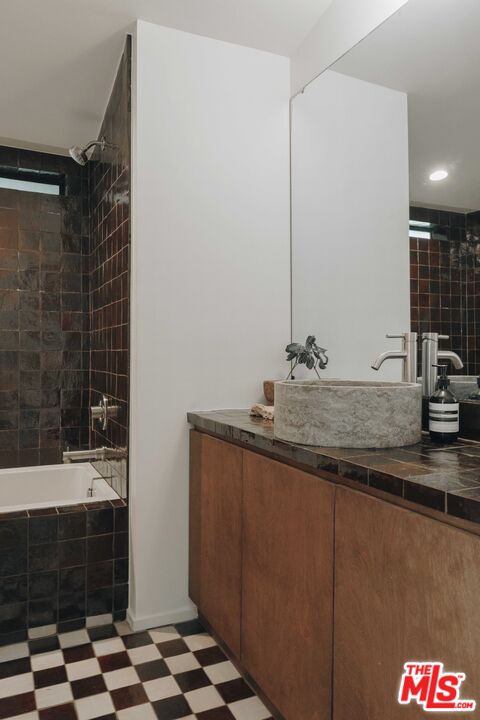 29500 Heathercliff Road, Unit 220 Malibu, CA 90265 - Photo 27 of 43 a bathroom with a sink and a mirror