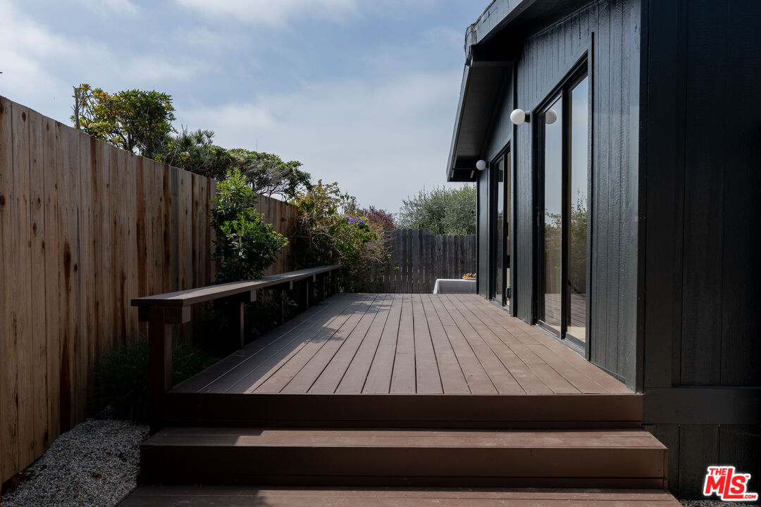 29500 Heathercliff Road, Unit 220 Malibu, CA 90265 - Photo 31 of 43 a view of backyard with wooden floor and fence